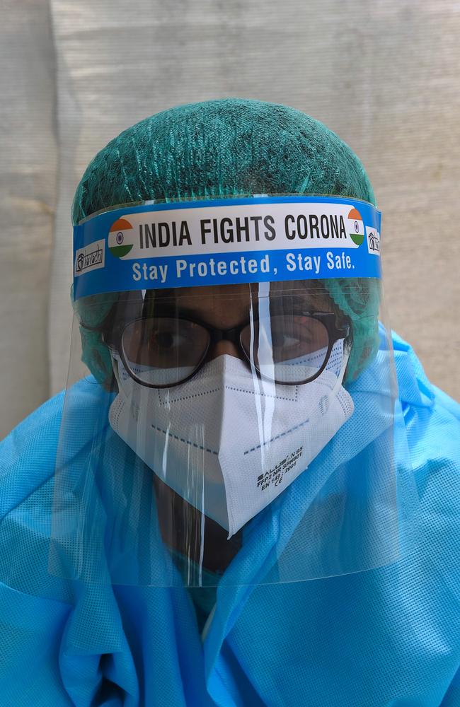 A health worker wearing a face shield reading 'India Fights Corona' waits for patients at a temporary COVID-19 coronavirus testing centre in Ahmedabad on September 19. Picture: Sam Panthaky