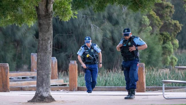 Blacktown Police search Lake Woodcroft for evidence after a group of men stabbed a man in a botched robbery on December 2. Picture: Dean Asher