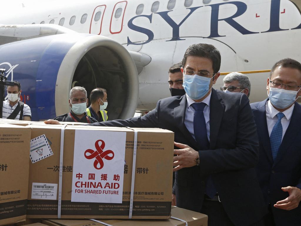 Syrian Health Minister Hassan al-Ghabash and the Chinese Ambassador Feng Biao (R) oversee the unloading of aid boxes of Sinopharm COVID-19 vaccine, donated by China. Picture: AFP