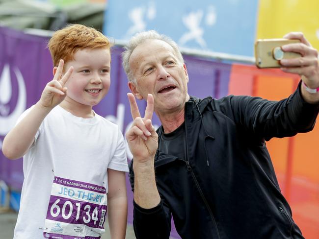 Jed ÒThe jetÓ Kennedy, 6, with grandfather Rob Ercoli take a photo for posterity at the finish of the Two Kilometre Junior Dash Pics Tim Marsden