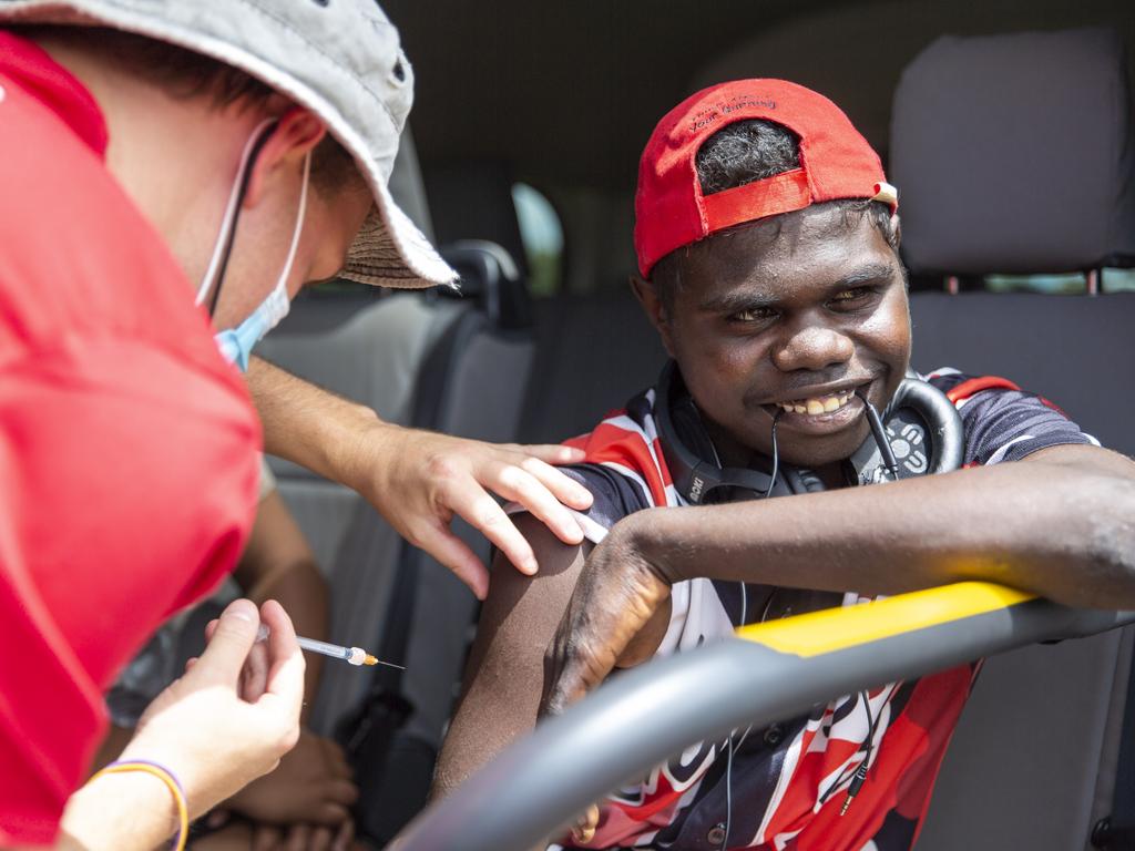 NT Health nurse Aydan Boscheinen administers Wurrumiyanga resident Iranaus Orsto his second Covid-19 vaccine while sitting in the vaccine van last week. Picture: Floss Adams.