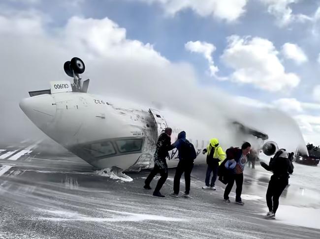 Images shot  by passenger Pete Koukov who was on a Delta Air Lines plane that crashed while landing Monday afternoon at the snowy Toronto Pearson International Airport. Picture: Pete Koukov/@eggxit Instagram