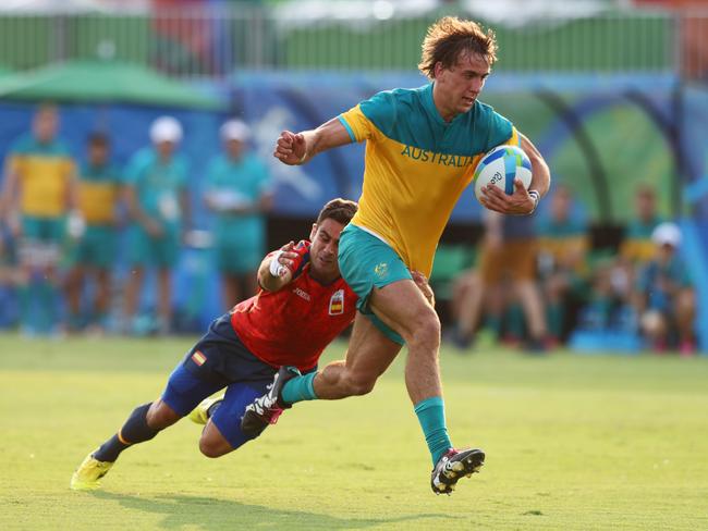 RIO DE JANEIRO, BRAZIL - AUGUST 09: John Porch of Australia attempts to break through during the Men's Rugby Sevens Pool B match between Australia and Spain on Day 4 of the Rio 2016 Olympic Games at Deodoro Stadium on August 9, 2016 in Rio de Janeiro, Brazil. (Photo by David Rogers/Getty Images)