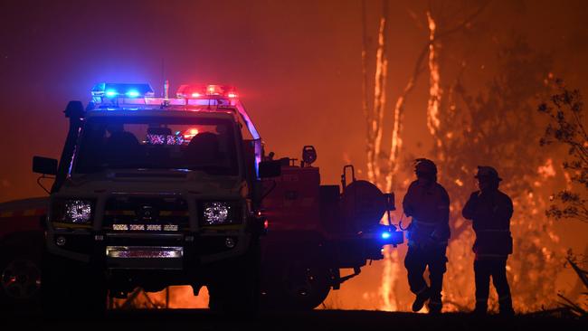 NSW Rural Fire Service crews protect properties as flames approach Mangrove Mountain, north of Sydney, in December. Picture: Dan Himbrechts/AAP