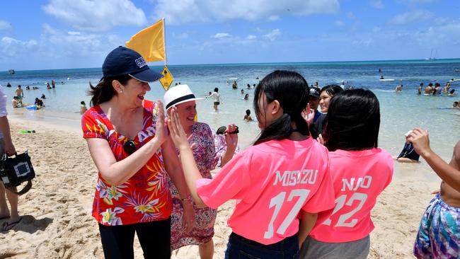 Queensland Premier Annastacia Palaszczuk is seen with tourists on Green Island. Picture: AAP Image/Darren England.