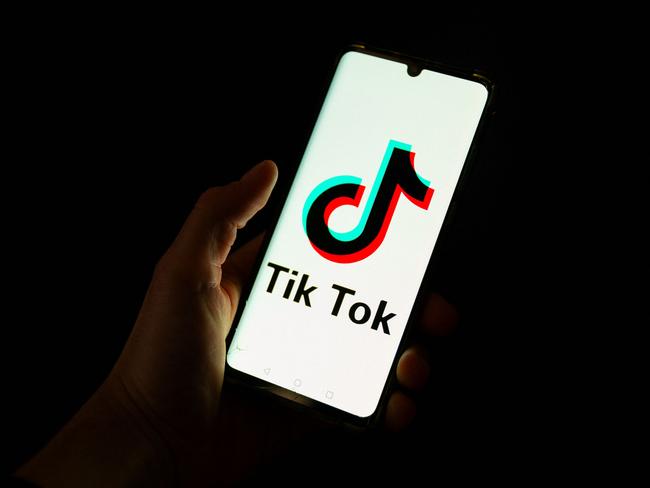 (FILES) This photograph taken on April 19, 2024 shows a man holding a smartphone displaying the logo of Chinese social media platform Tiktok in an office in Paris. TikTok faces an imminent shutdown in the United States after Congress passed a law last year forcing its Chinses owner ByteDance to either sell the platform or close it by this January 19, 2025. The US Supreme Court is expected to rule this week on TikTok's challenge to the law. (Photo by Antonin UTZ / AFP)