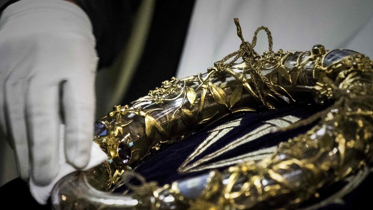 A priest wiping the Crown of Thorns, a relic of the passion of Christ which is housed at Notre-Dame. Picture: AFP 