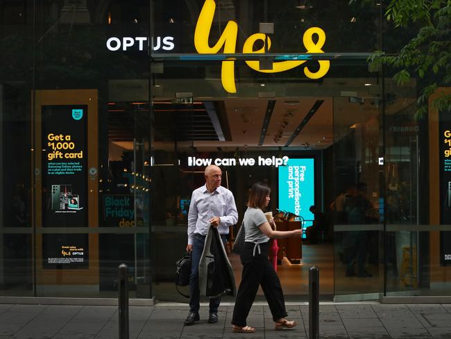 SYDNEY, AUSTRALIA - NOVEMBER 21: Pedestrians walk past an Optus store in the CBD on November 21, 2023 in Sydney, Australia. Optus' CEO Kelly Bayer Rosmarin stepped down on Monday after an extended outage last week caused millions of Australians to be disconnected from the network, with no access to emergency numbers for hours. The outage followed a hack that saw millions of customers' data shared online last year. (Photo by Lisa Maree Williams/Getty Images)