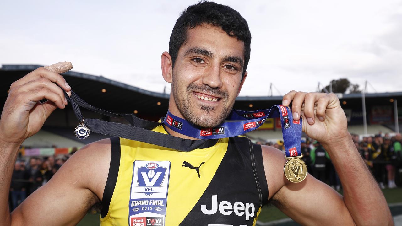 Marlion Pickett poses after winning the Norm Goss Medal on Sunday.