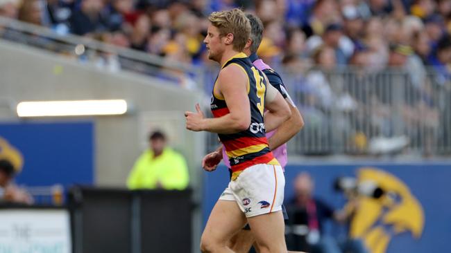 Rory Sloane leaves the field with blurred vision after some friendly fire from teammate Matt Crouch. Picture: AAP Image/Richard Wainwright