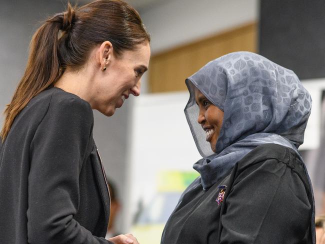 New Zealand Prime Minister Jacinda Ardern greets a first responder of the Christchurch attacks. Picture: Getty Images