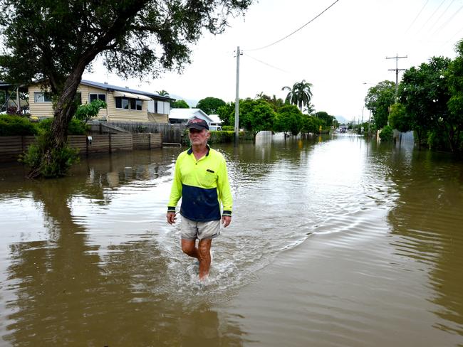 Townsville Floods: Hermit Park resident Ross Cribbin walks through part of Hodel Street still flooded. Picture: Evan Morgan