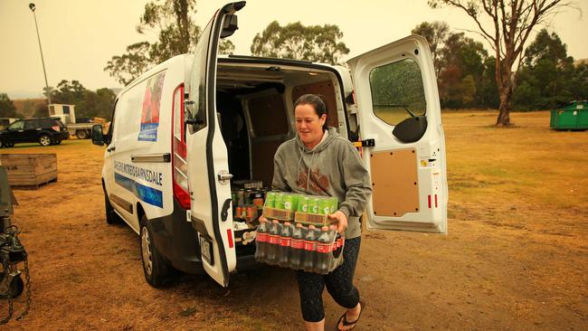 The trucks carting hay also carried toiletries, clothes and non-perishable items for the locals. Picture: Mark Stewart