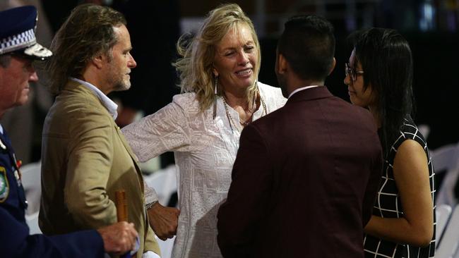 Tori Johnson’s father Ken Johnson and mother Rose Connellan talking with Joel Herat and Fiona Ma after the ceremony at Martin Place, Sydney. Picture: Jonathan Ng