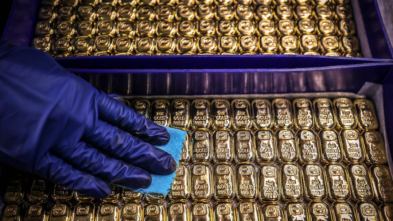 A worker polishes gold bullion bars at the ABC Refinery in Sydney. Picture: DAVID GRAY AFP)