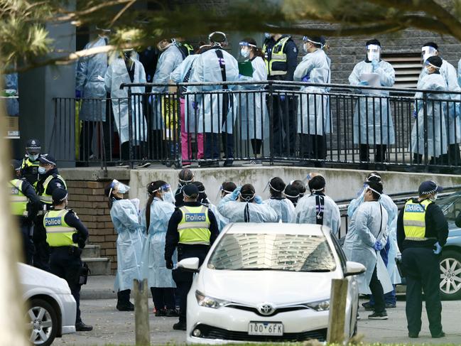 Lines of Healthcare professionals are seen entering the North Melbourne Public Housing tower complex where mass COVID-19 tests are being conducted. Picture: Getty