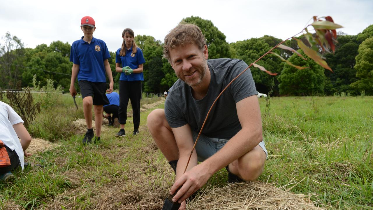 Byron Shire deputy mayor Michael Lyon plants a koala food tree on a Binna Burra property. Mullumbimby High School students have launched the Trees for Koalas - Connecting Communities project, aimed at increasing the number of koala food trees on private properties within the Byron Shire. The group toured this Binna Burra property on Tuesday, October 27, before planting 400 new koala food trees to build upon existing plantation works. Picture: Liana Boss