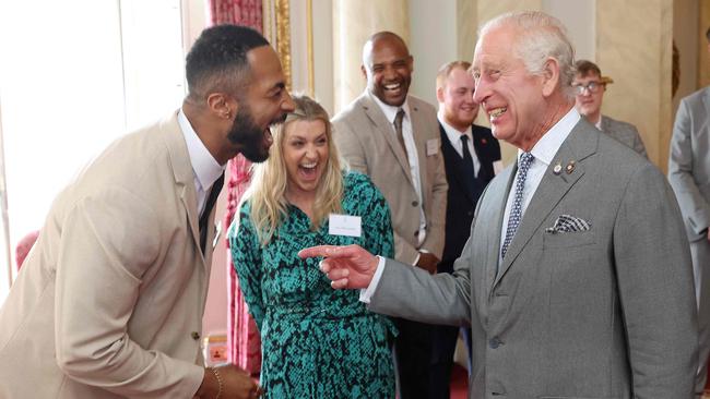 Britain's King Charles III (R) reacts as he fists bumps with Tyler West during a ceremony for the Prince's Trust Award 2024 winners and celebrity ambassadors, at Buckingham Palace, in London, on May 22, 2024. (Photo by Chris Jackson / POOL / AFP)