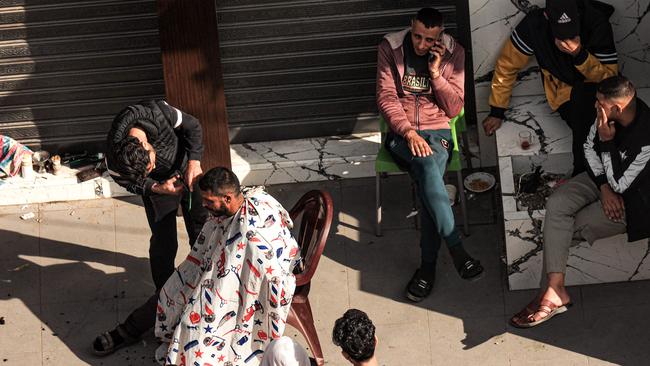 A Palestinian man gets a haircut in Rafah in the southern Gaza Strip on Friday. Picture: Said Khatib/AFP