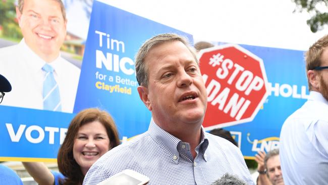 Queensland Opposition Leader Tim Nicholls is surrounded by anti-Adani protestors as he arrives to vote at St John Anglican Church in Hendra. Picture: AAP Image/Tracey Nearmy