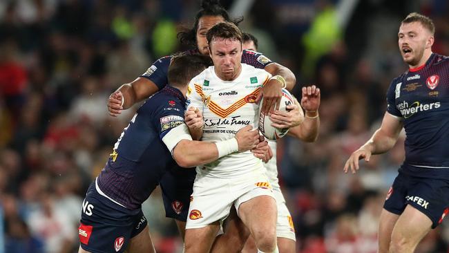 MANCHESTER, ENGLAND - OCTOBER 09: James Maloney of Catalans Dragons is tackled by Agnatius Paasi and LMS of St Helens during the Betfred Super League Grand Final match between Catalans Dragons and St Helens at Old Trafford on October 09, 2021 in Manchester, England. (Photo by Jan Kruger/Getty Images)