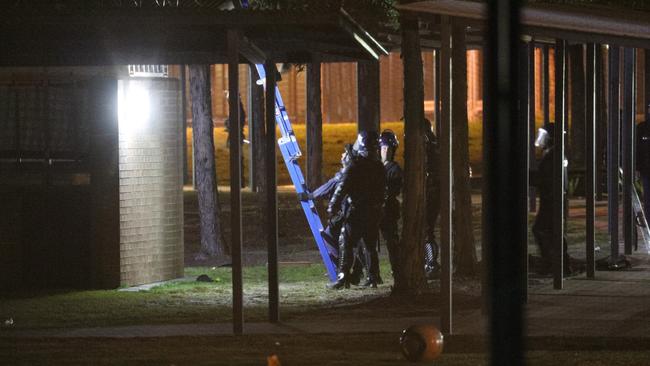 Riot police look to access the roof at Frank Baxter Correctional Centre where inmates rioted. Picture: Dean Asher