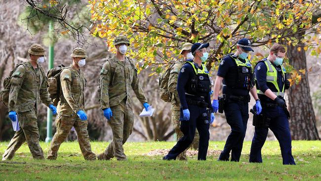 Victoria Police are supported by ADF personnel as they patrol the city. Picture: Mark Stewart