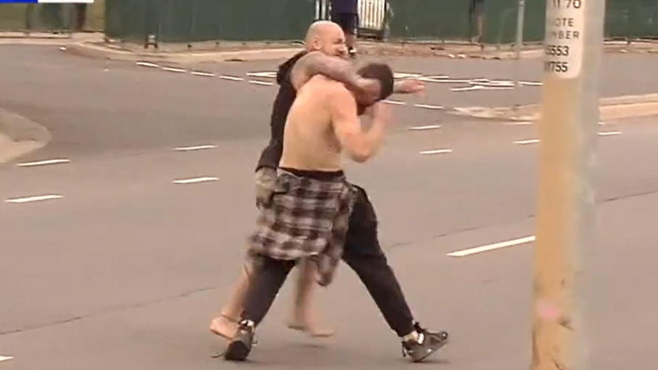 The two men were filmed trading blows in the middle of the street as horrified students and parents watched on