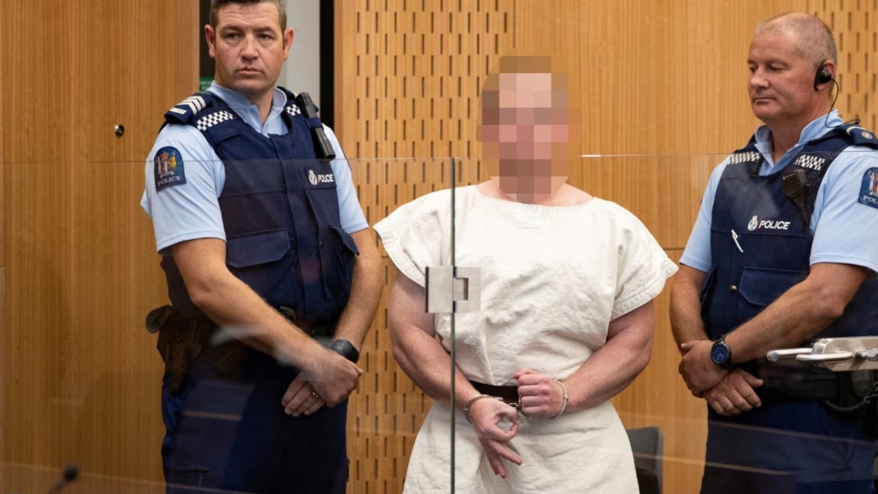 Brenton Tarrant gives a white power symbol in court