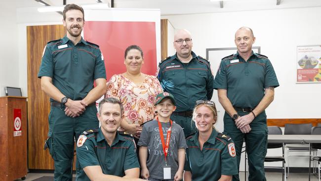 Paramedic Luke Baker, mother Paula Apostoles, Toby Bugter, Jeff Bates, and (front) Dan Robertson, survivor Harrison Grey and Ella McCue all reunite after the horrific incident that almost killed Harrison. Picture: Floss Adams.