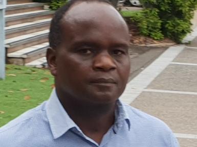 John Mugambi Mwamba  (right) as supported by Defence lawyer Mathai Joshi in his appearance at the Townsville Magistrates Court on Tuesday.  Photo: Leighton Smith