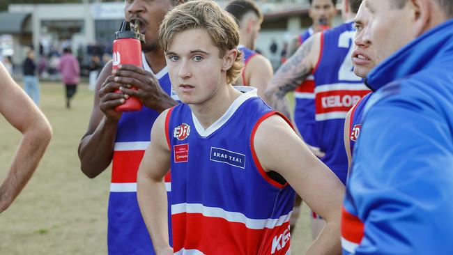 Thomas McGuane (centre) listens as his dad and Keilor coach Mick McGuane gives instructions at 3 quarter time against Doutta Stars. Picture: Ian Currie