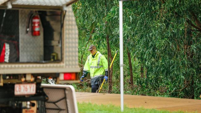 Police at the scene of the discovery of the body in a creek off Damabila Drive. Picture: Glenn Campbell