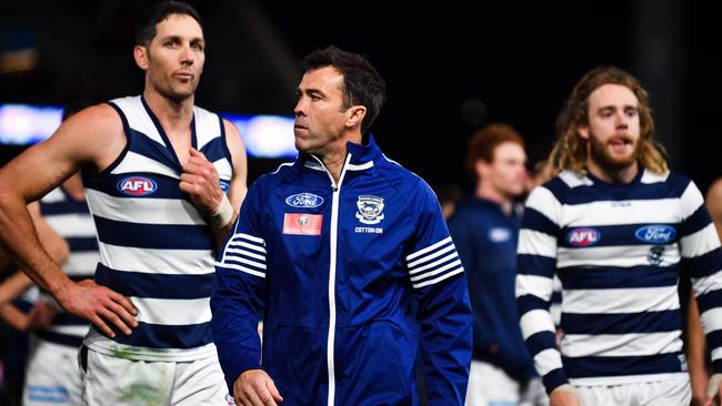 Geelong coach Chris Scott walks off Adelaide Oval in front of Harry Taylor and Cameron Guthrie after the Round 14 loss to the Power. Picture: Daniel Kalisz/Getty Images.