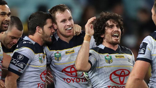 Cowboys players Michael Morgan, Lachlan Coote and Jake Granville celebrate the win.
