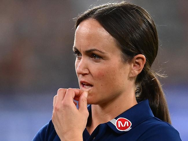 MELBOURNE, AUSTRALIA - MARCH 17: Daisy Pearce looks on as Cats head coach Chris Scott  speaks to his players  during the round one AFL match between Geelong Cats and Collingwood Magpies at Melbourne Cricket Ground, on March 17, 2023, in Melbourne, Australia. (Photo by Quinn Rooney/Getty Images)