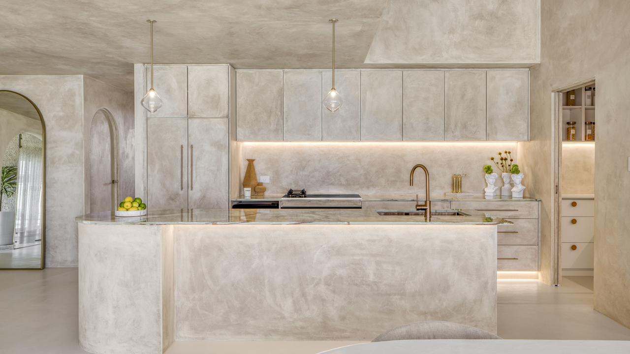 The kitchen includes a marble island bench and butler’s pantry