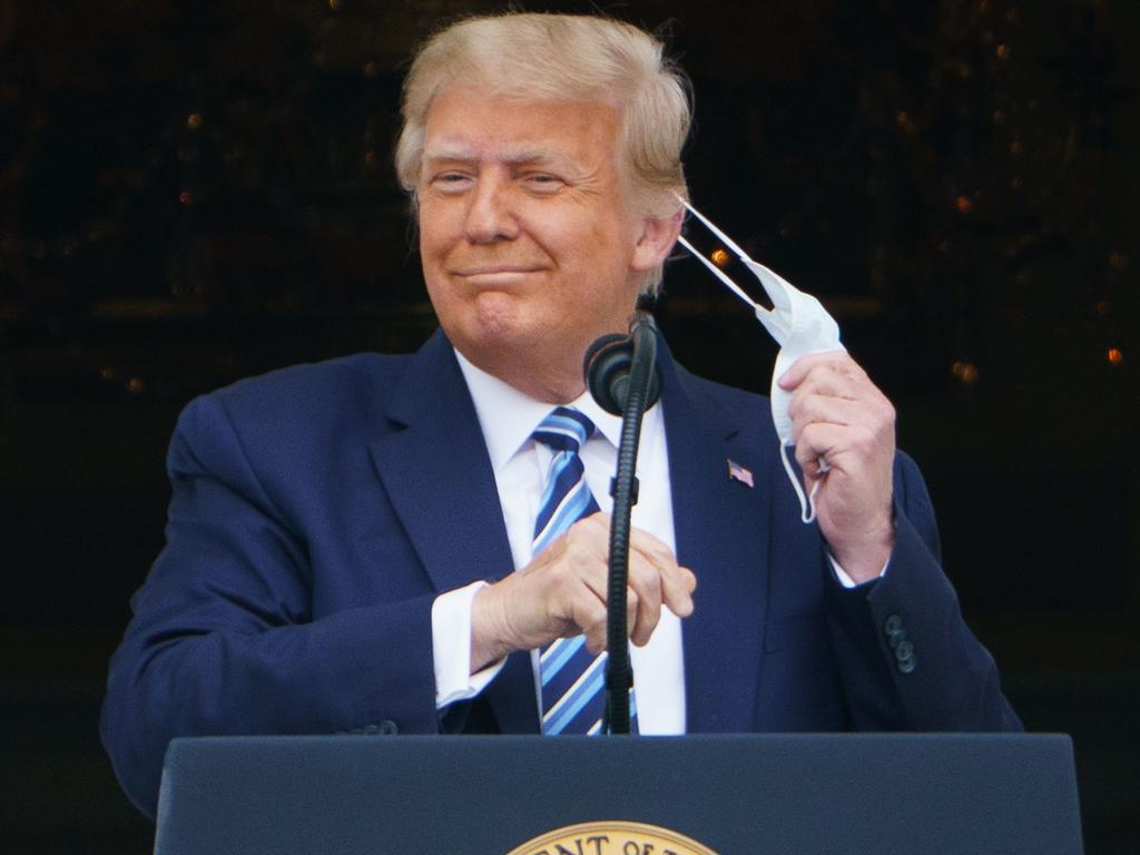 US President Donald Trump takes his mask off after returning to the White House from hospital following treatment for COVID-19. Picture: Mandel Ngan/ AFP