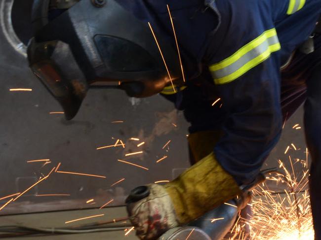 Portland - Keppel Prince manufactures wind turbines and employs staff from the local community. They are also in the process of constructing stadium light towers for Geelong, pictured in the b/g as boilermaker Matt Malseed grinds.