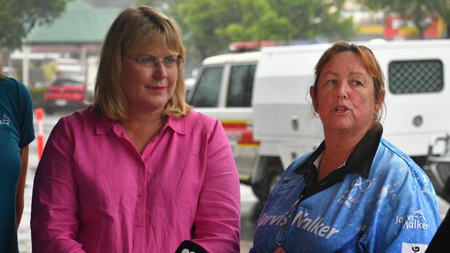 Hinchinbrook Shire Council Deputy Mayor Mary Brown (right), flanked by Minister for Local Government and Water and Minister for Fire, Disaster Recovery and Volunteers Ann Leahy, speaking outside the council headquarters in flood-ravaged Ingham on Tuesday. Picture: Cameron Bates