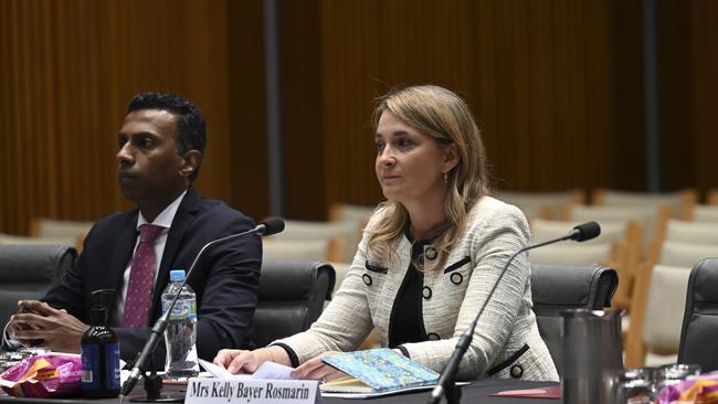 Lambo Kanagaratnam flanked the Optus boss during Friday’s hearing. Picture: NCA NewsWire / Martin Ollman