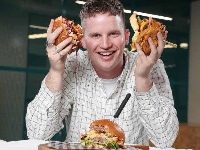 The Daily Telegraph’s Mitchell Van Homrigh helps judge Sydney's best burgers. Picture: Richard Dobson