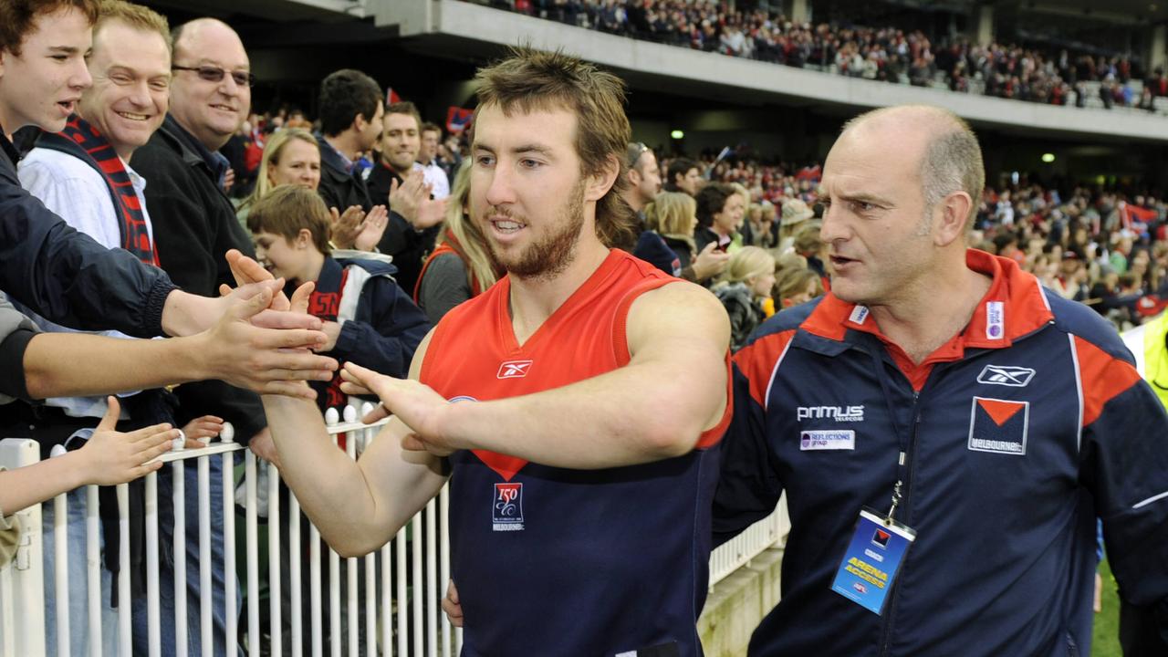 Former Demons coach Dean Bailey (right) congratulates Brock McLean after a Melbourne win.