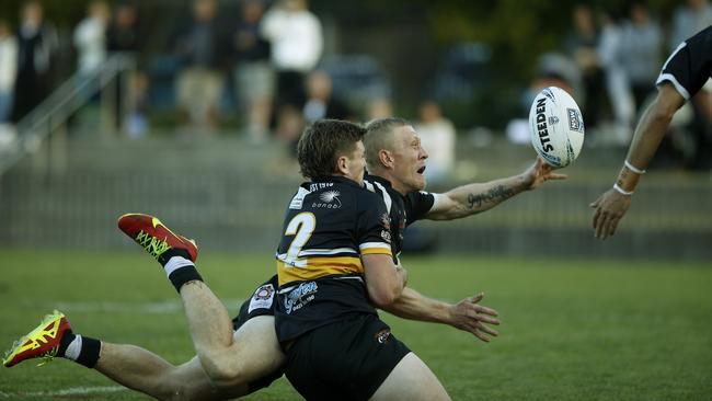 Redfern's Jay Belgrove gets the ball away for the try that clenched the match for Redfern. Picture: John Appleyard