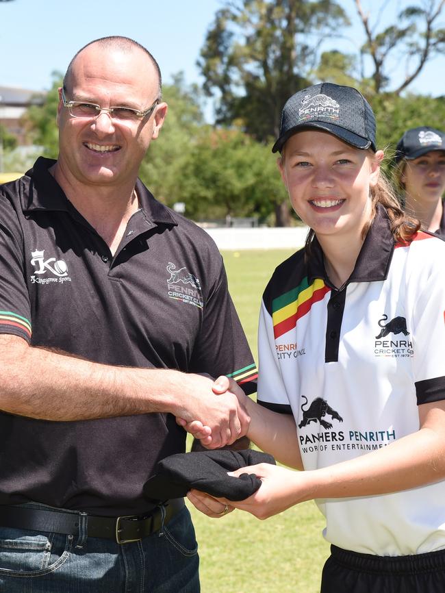 President Paul Goldsmith hands Amy Edgar her new cap.