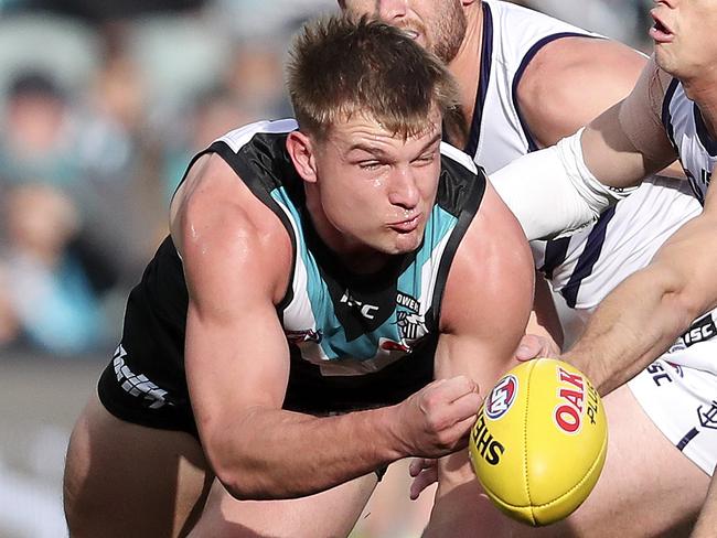 AFL - Port Adelaide v Fremantle at Adelaide Oval. Ollie Wines about to charge off from Connor Blakely and Nat Fyfe Picture SARAH REED