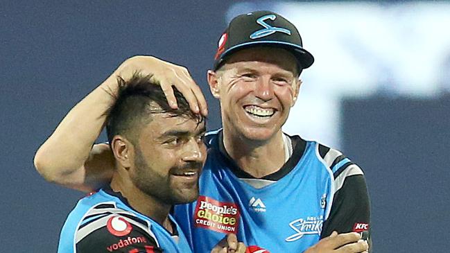 Peter Siddle (right) with Rashid Khan. Picture: AAP Image/Jono Searle.