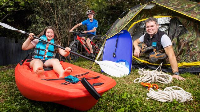 CEO of Outdoors Victoria Andrew Knight in his backyard with children Keira, 11, and Patrick, 13. Picture: Mark Stewart