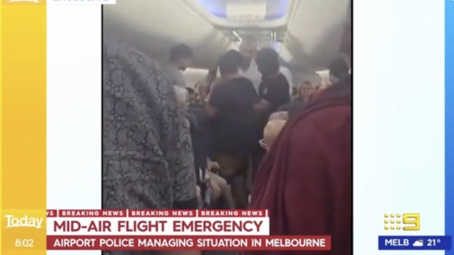 Chaos on Qantas flight as man detained (9 News)