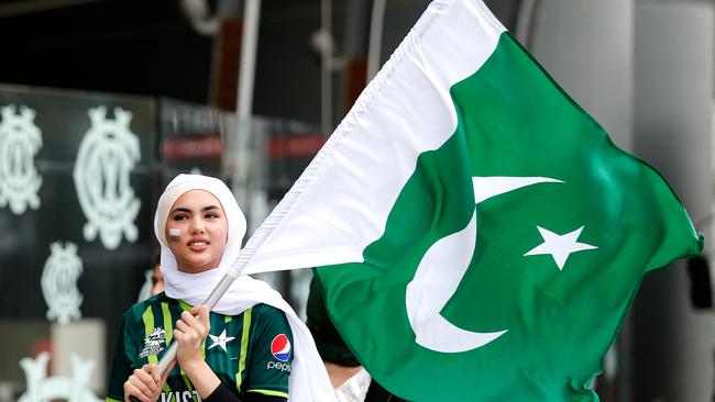 A Pakistani fan arrives with the national flag. Photo by Surjeet Yadav / AFP